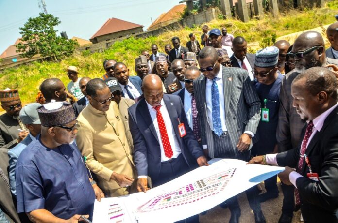 Government officials inspect plans for the confiscated 753-unit Lokogoma housing estate in Abuja.