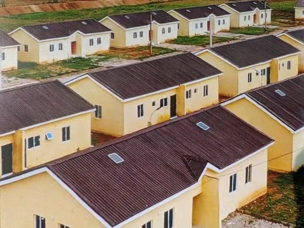 Aerial view of a residential estate with rows of newly built single-storey houses and landscaped plots.