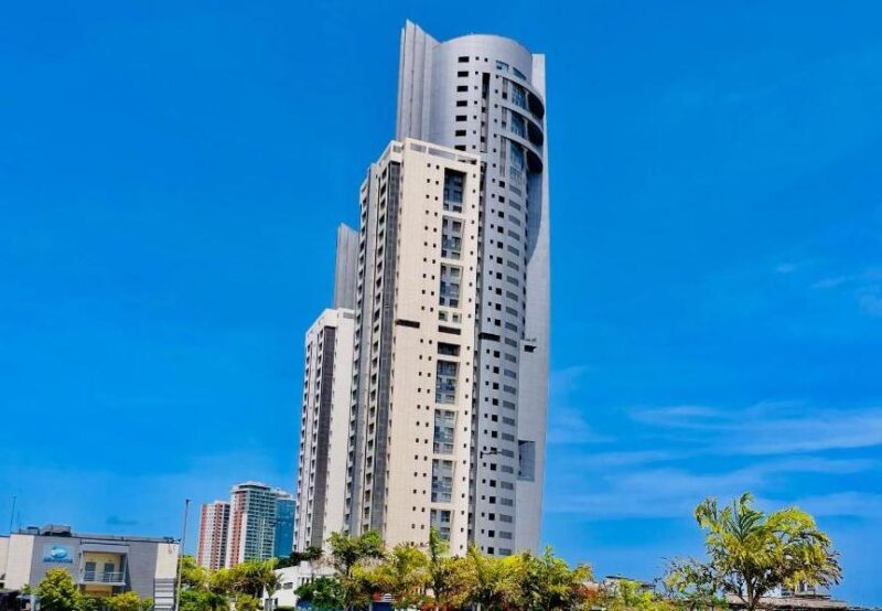 Luxury high-rise apartment building against a clear blue sky, representing Lagos’ high-end residential property market.